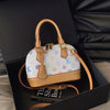 2025 Model Shell Bag. Made of Fashionable PU Material, It Is Decorated with Rivets and Can Be Carried by Hand.6036